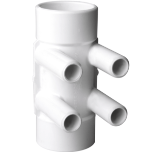 White PVC plumbing manifold with four side outlets around a central vertical body used for distribution of pipes.